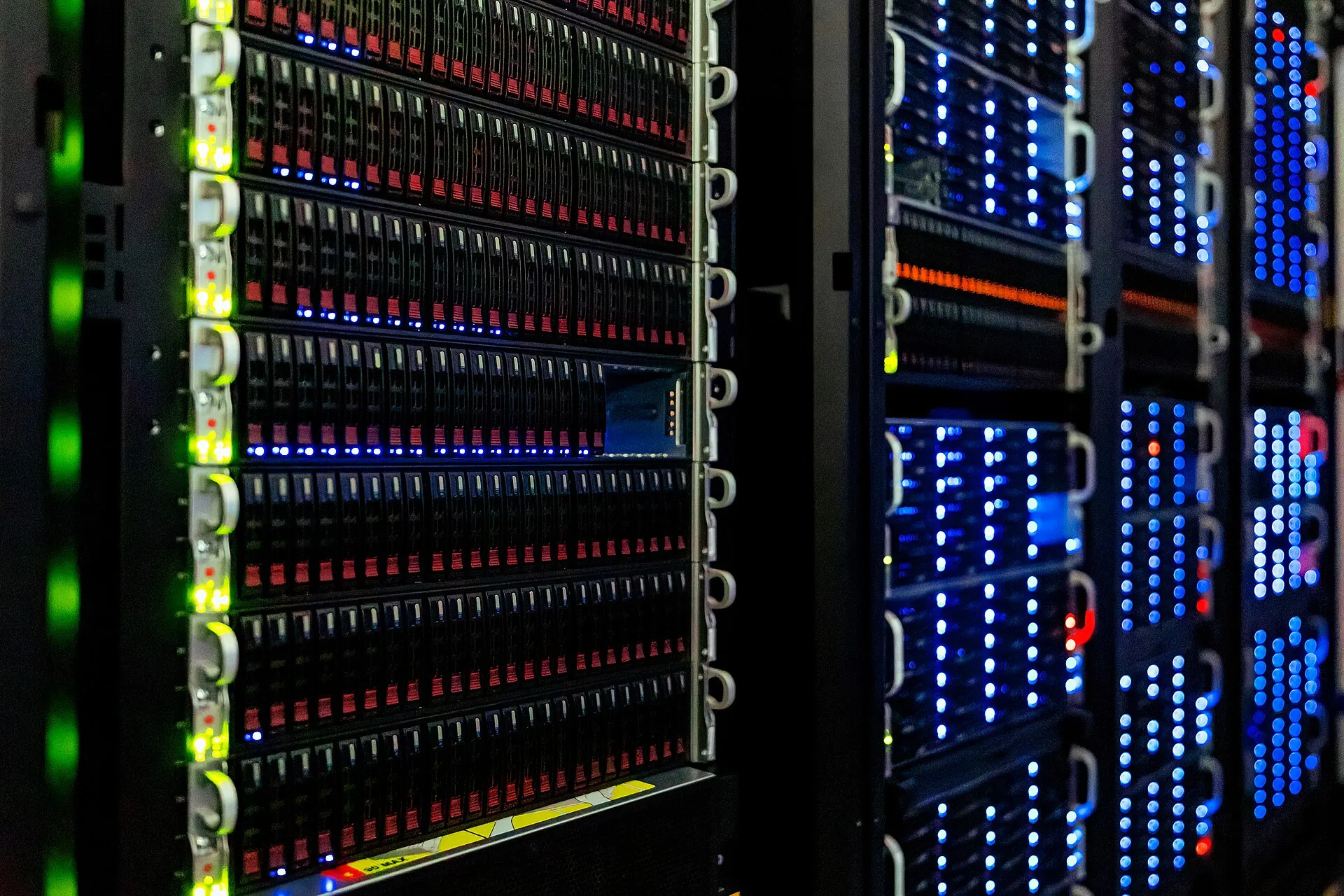 Server racks glowing in a dark data center